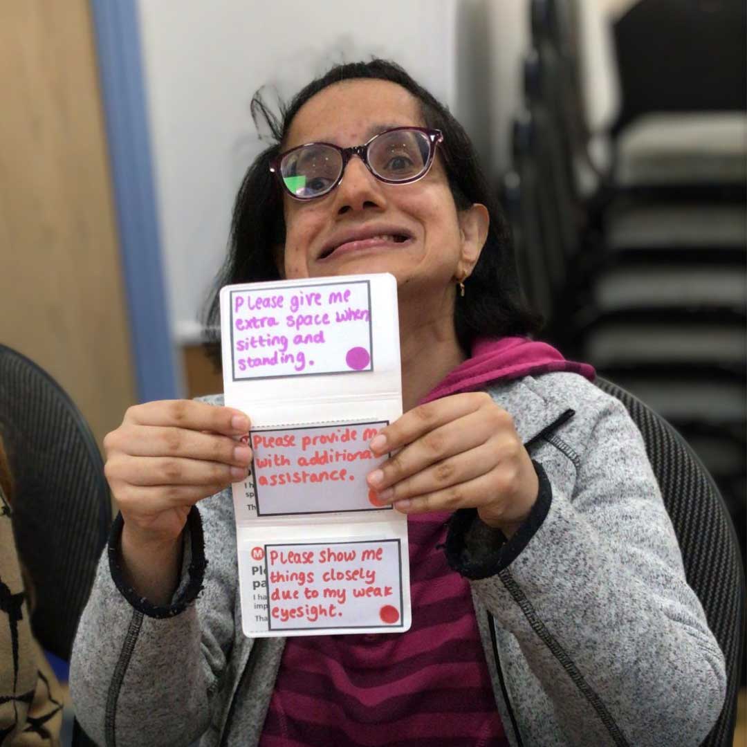 TWC-client-pic A member of one of our groups, holding up some safe travel cards.